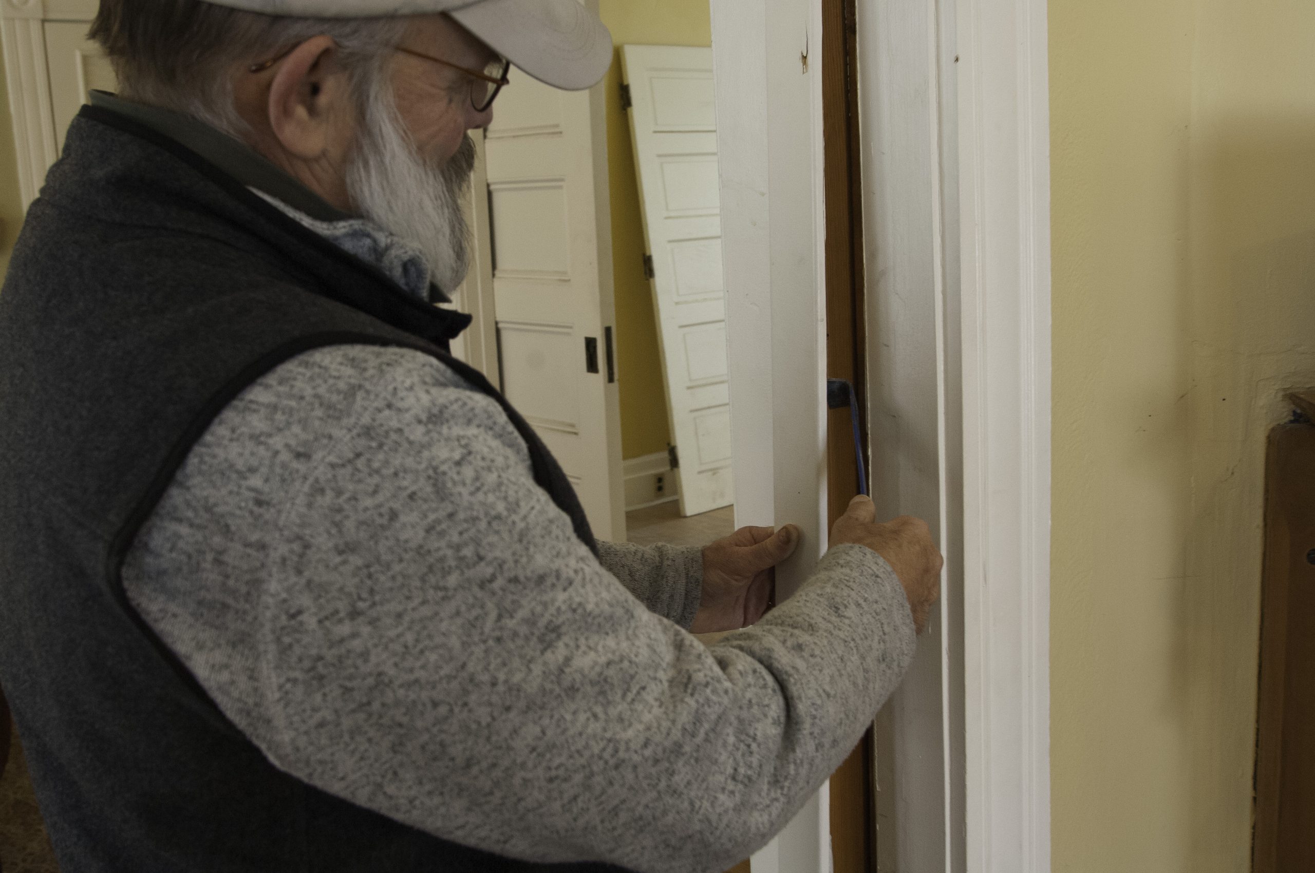 Pry trim from pocket door