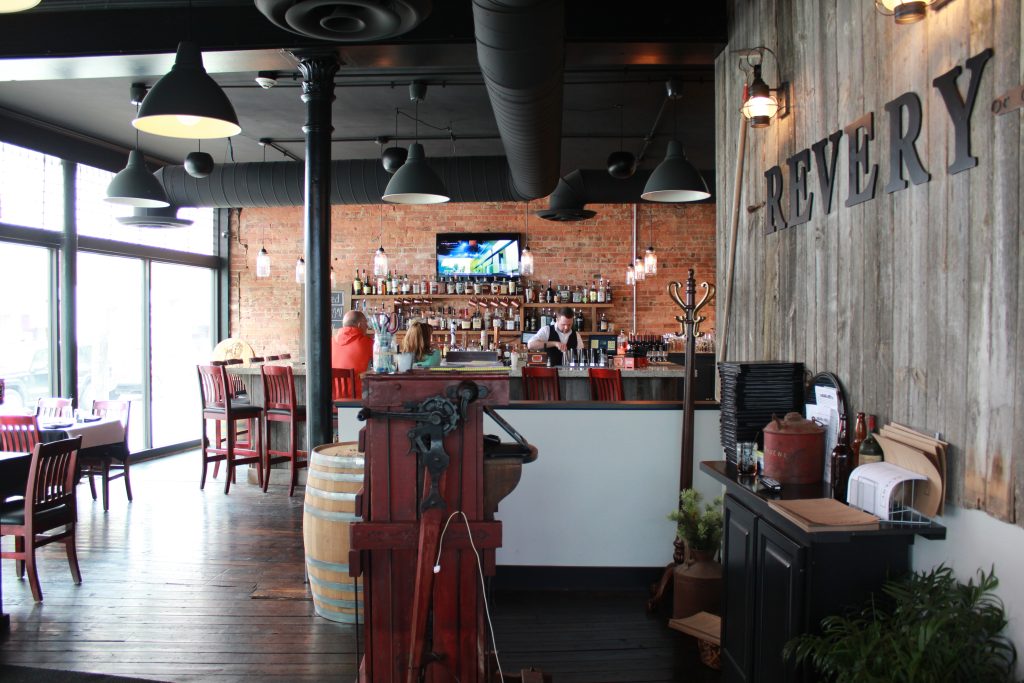 In converting the landmark to a restaurant, workers removed carpeting to reveal the original wood floors and removed drop ceilings.